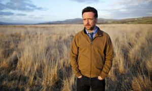 Richard Harrington as DCI Matthias in Hinterland, standing in a field, looking a bit sad.