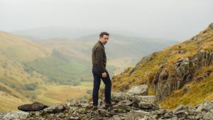 DCI Matthias stands on the side of a mountain.