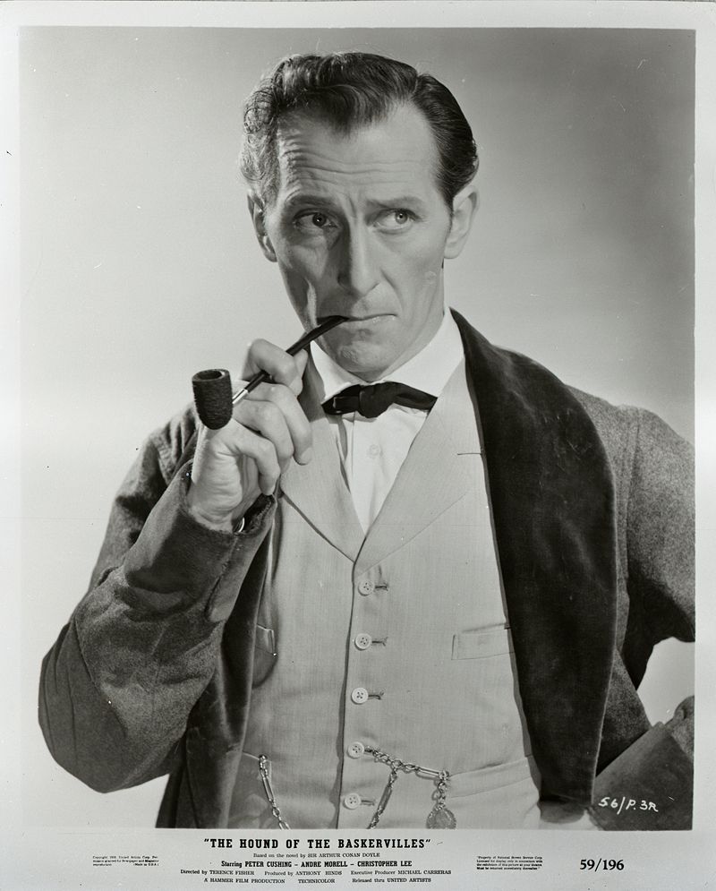 Peter Cushing as Sherlock Holmes in "The Hound of the Baskervilles", smoking a pipe.